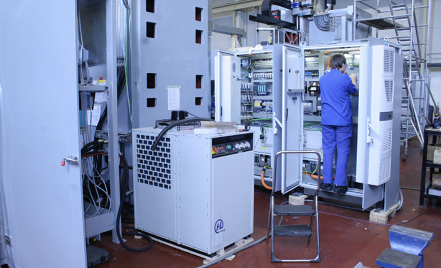 VTT-WB engineer working on a machine control cabinet